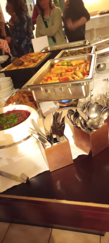 A table with various of Sudanese Dishes, along with cutlery and plates.